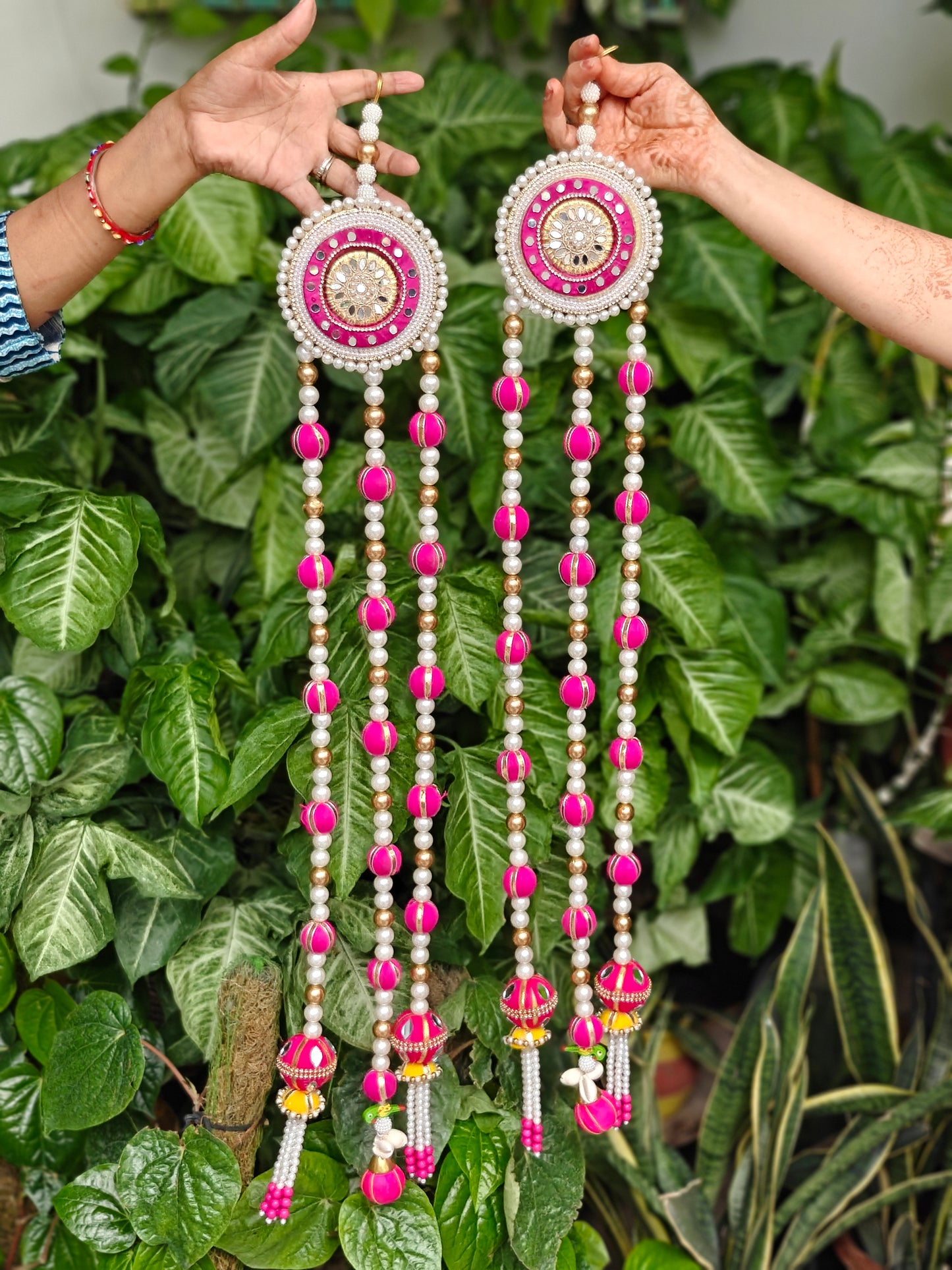 Pink and gold Diwali hanging with pearl detailing, embellished circular motifs and cascading decorative bead strands, 31 inches tall