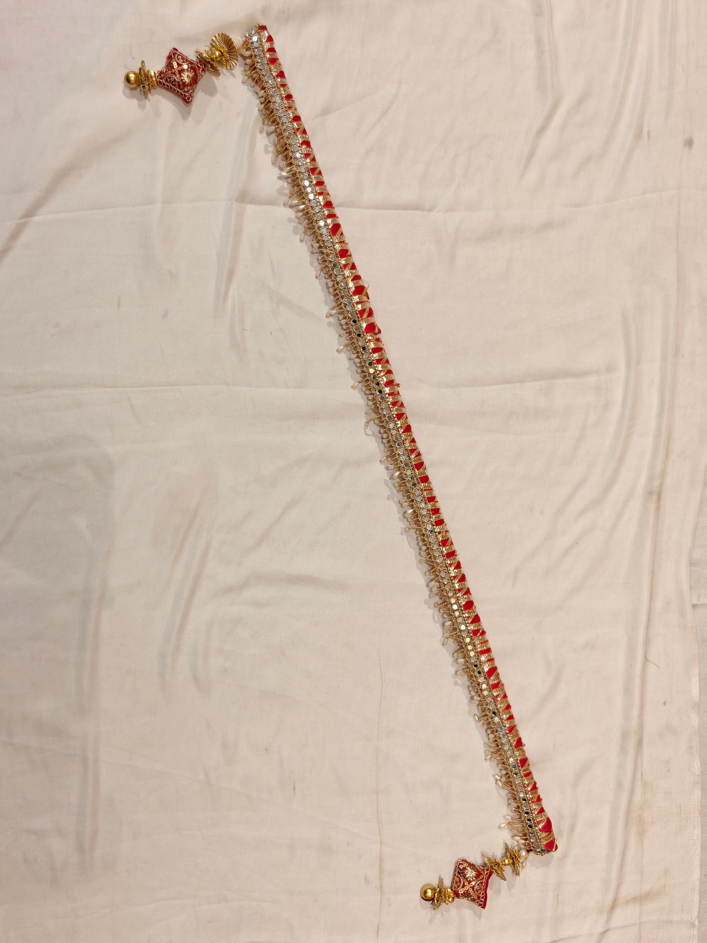 Handcrafted red and gold sarkanda for mandha wedding decoration with mirror work and pearl drops, full length view