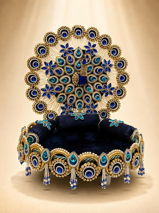 Handcrafted peacock singhaasan for Ladoo Gopal in royal blue and gold with gem embellishments, pearl beading, and detachable peacock feather backdrop — 12 inch MDF deity throne by The Wedding Station