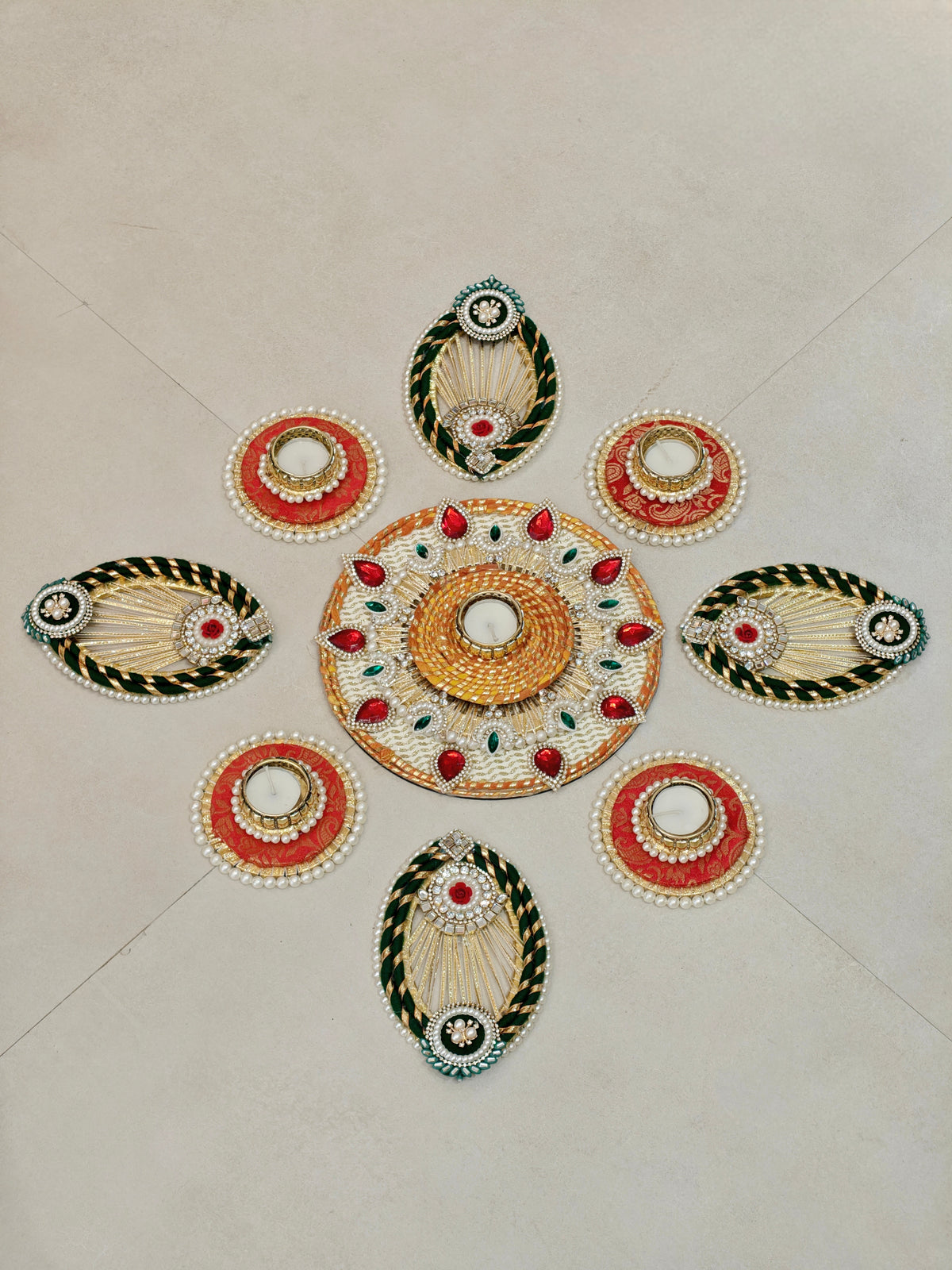 Ivory and red rangoli set with rose motifs and pearl tealight holders