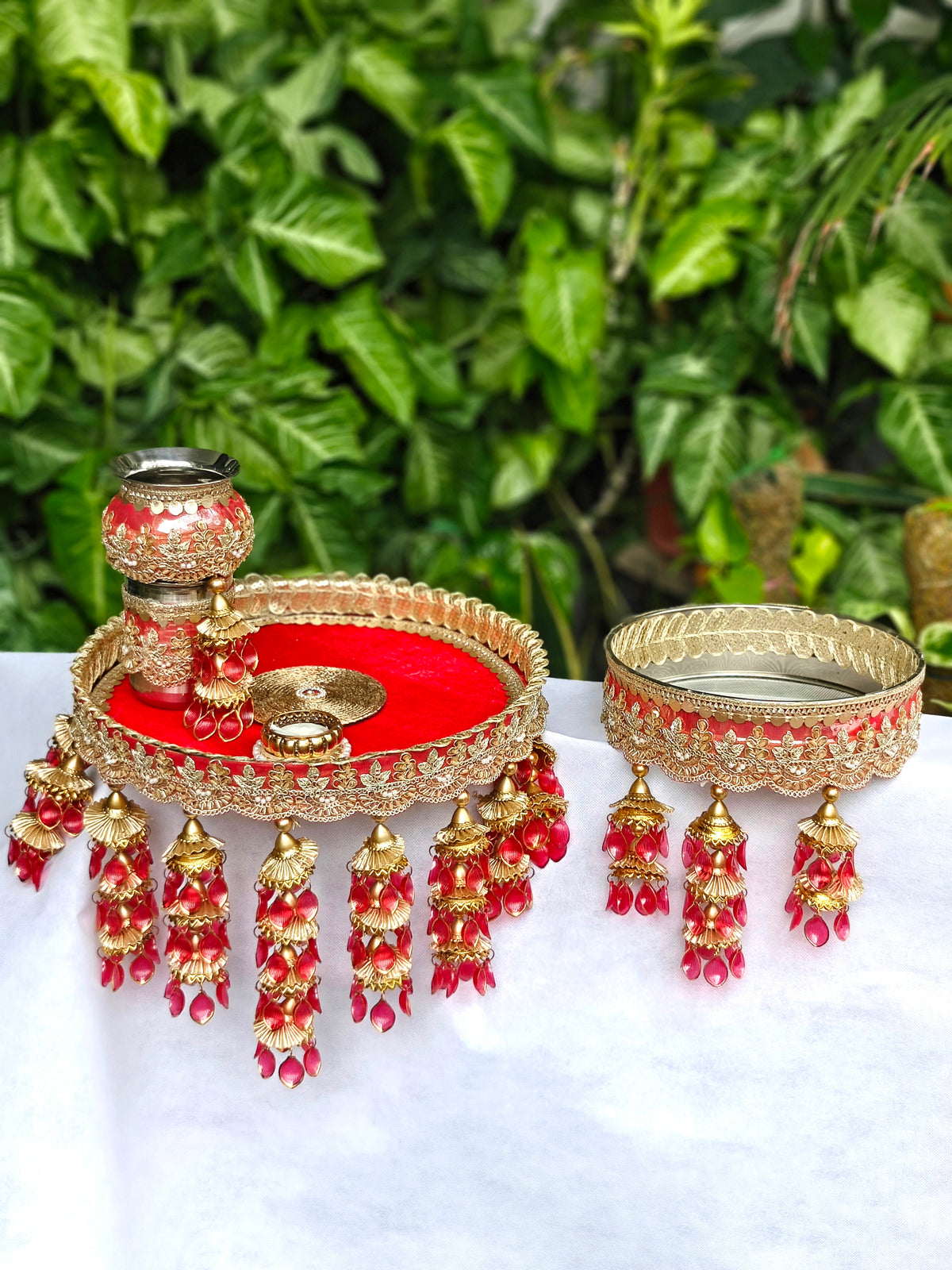 Royal red and gold Karva Chauth thali set with decorated steel thali, steel kalash, glass, candle, channi and red hanging latkans