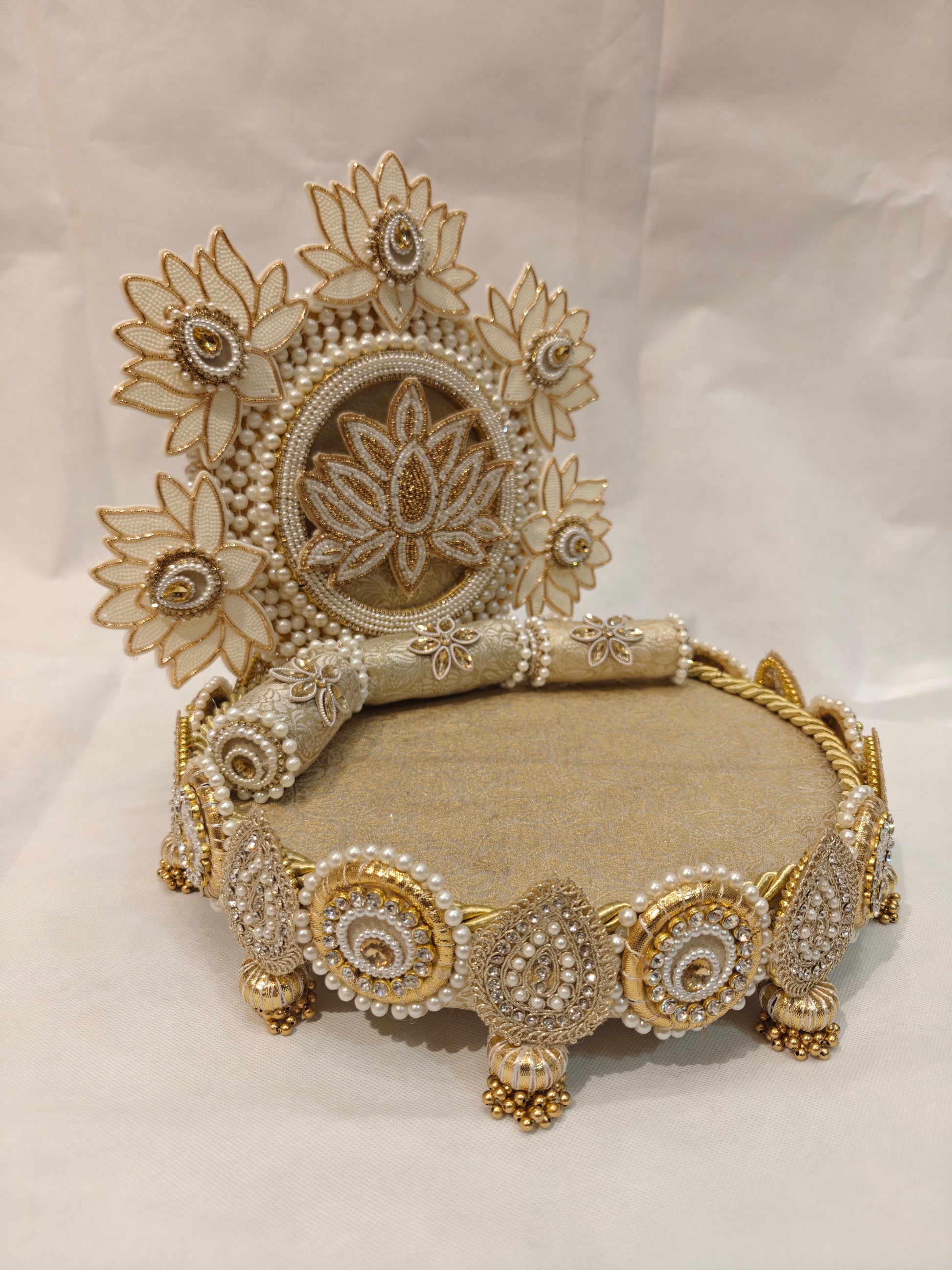 Angled view of handcrafted ivory lotus garden Singhaasan for Ladoo Gopal — 12 inch MDF deity throne with lotus flower backdrop, brocade seating and gem teardrop border by The Wedding Station