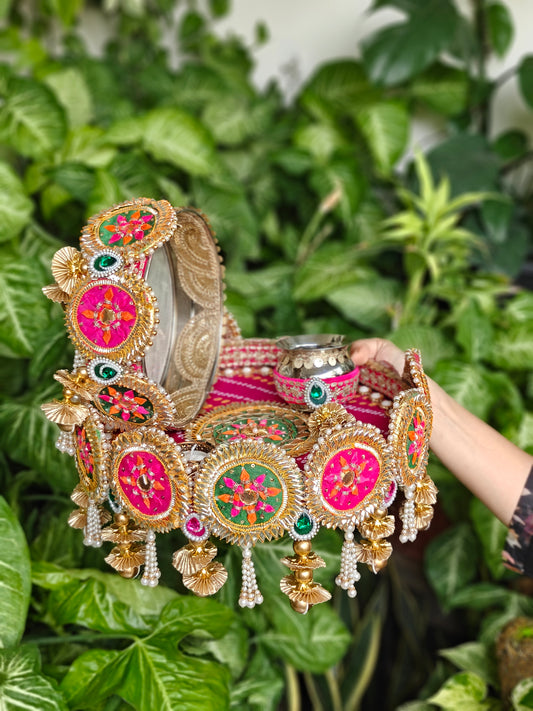 Rangrez Riwaayat colourful designer Karva Chauth thali set with decorated steel Channi, Kalash, pink green floral detailing and pearl hangings