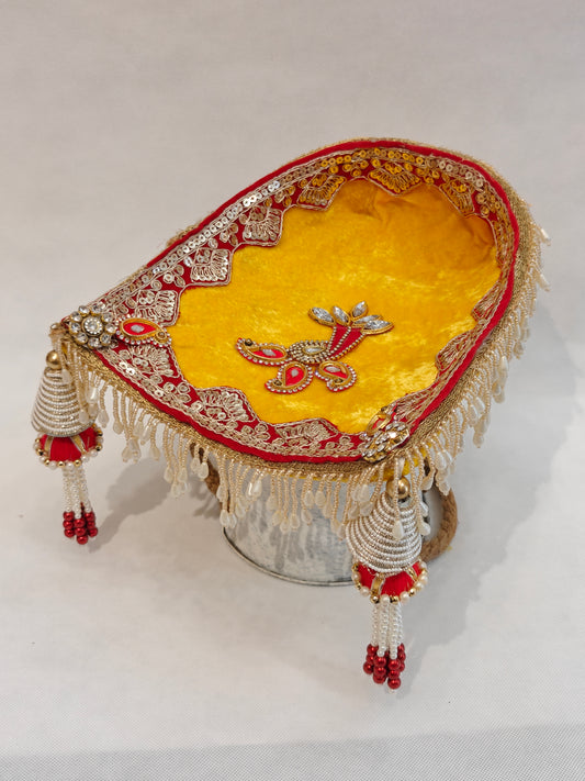 Yellow velvet soupda with red zari border, crystal peacock appliqué and white bead tassel drops — small Indian wedding ritual tray 8x7 inch by The Wedding Station