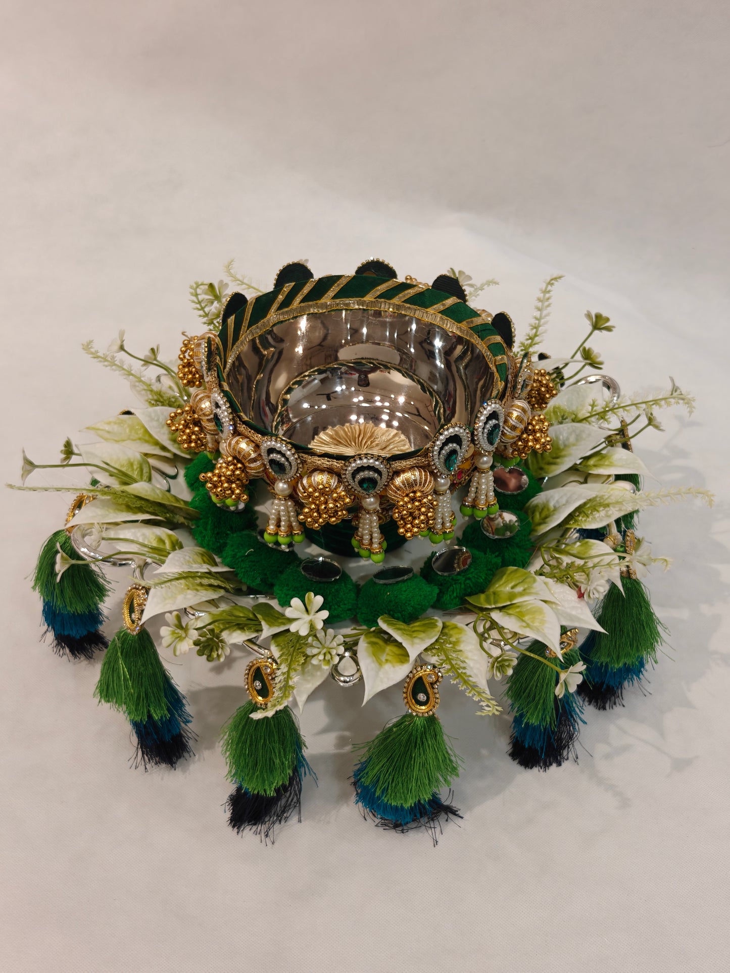 Handcrafted Mehendi ceremony platter with 12-inch silver plastic base, 6-inch metal bowl, green velvet cushion, white floral ring and three-tier peacock green teal navy silk tassels for wedding ritual