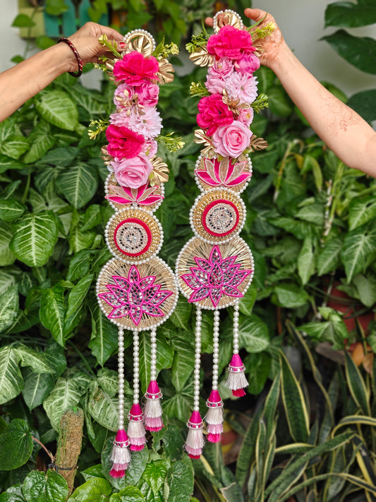 Pink floral Diwali hanging with lotus motifs, pearl embellishments, gold detailing and cascading pink and white tassels