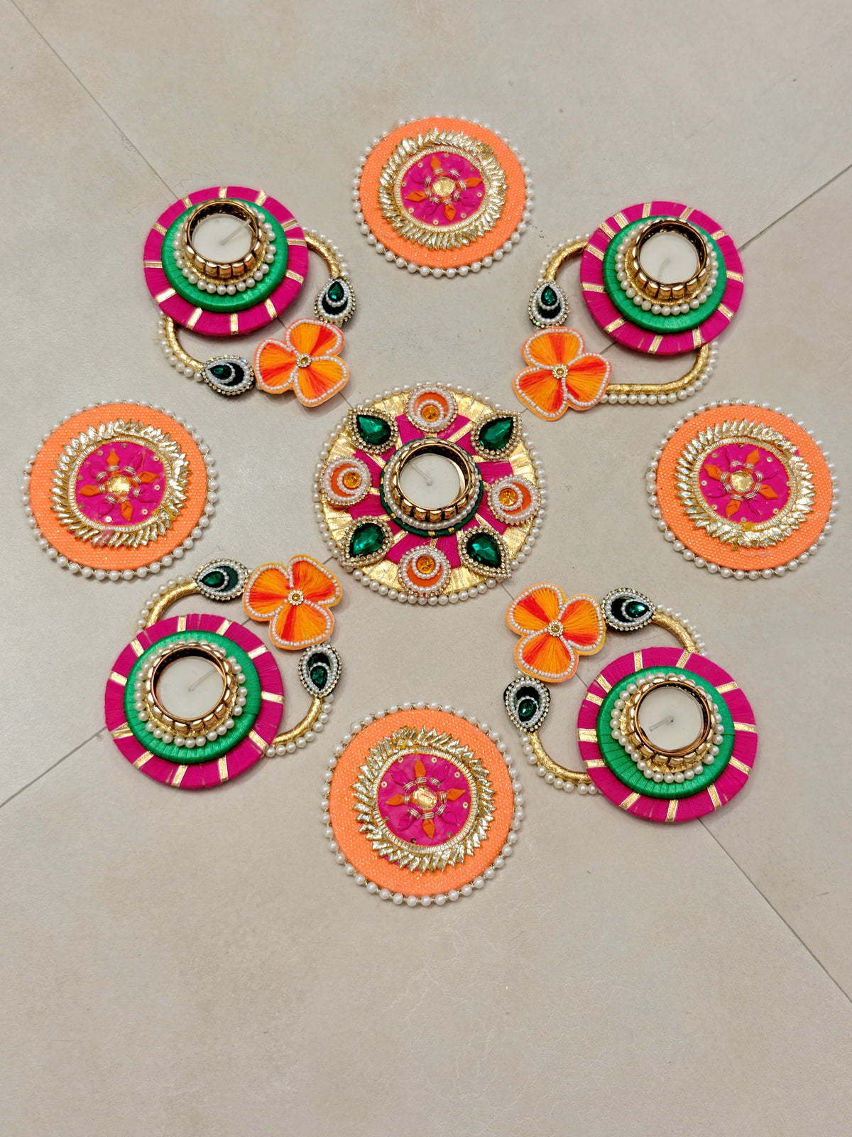 Coral and green floral rangoli set with tealight holders and gold beaded connectors