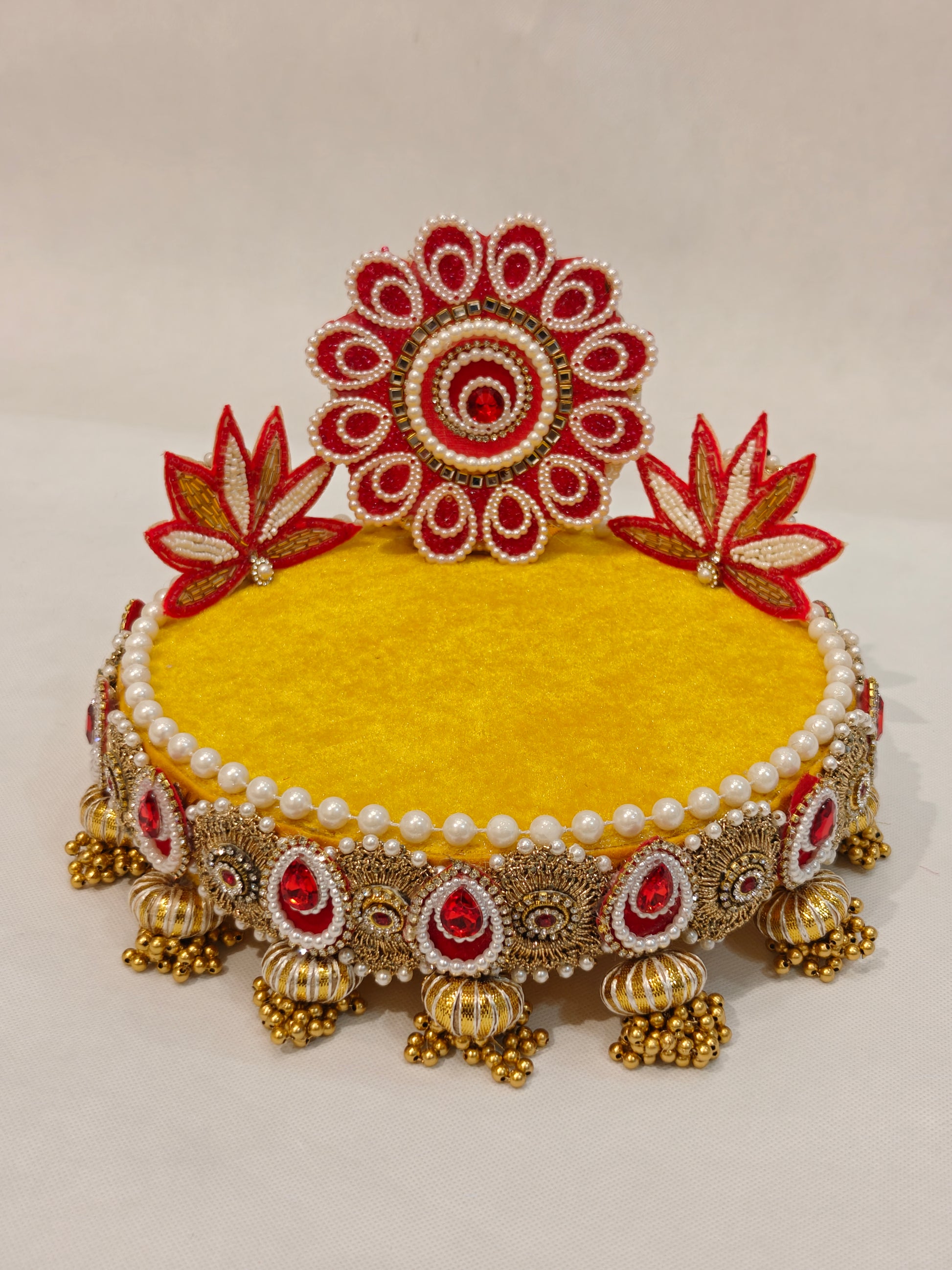 Handcrafted red and yellow lotus Singhaasan for Ladoo Gopal — 8 inch compact MDF deity throne with beaded red floral medallion crown, twin red lotus blooms, sunshine yellow velvet seating, ruby red gem teardrop border and gold ghungroo tassel drops by The Wedding Station