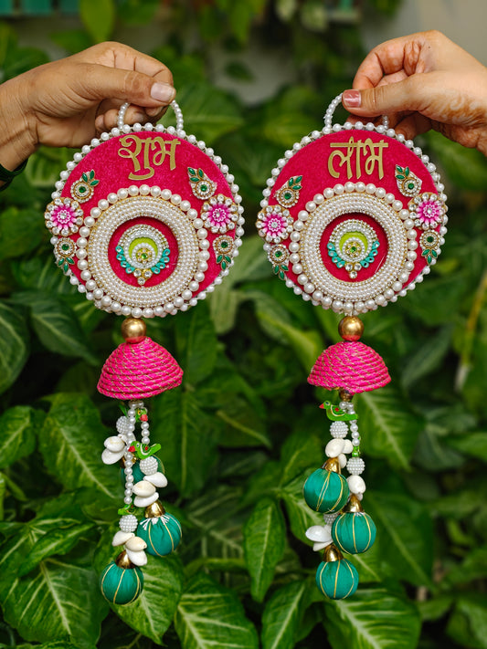 Pink Shubh Laabh Diwali hanging with pearl embellishments, green beaded tassels and traditional festive detailing