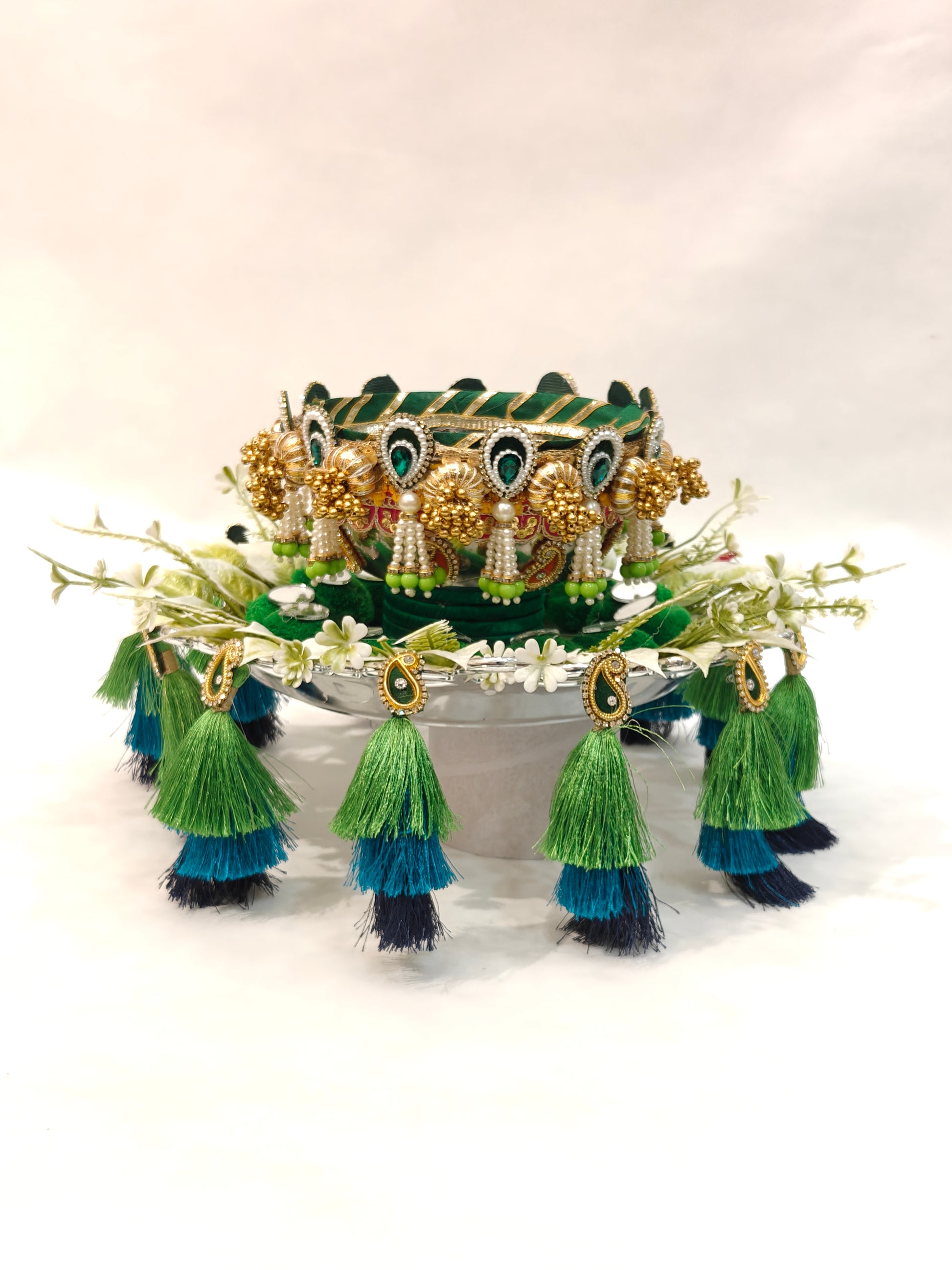 Handcrafted Mehendi ceremony platter with 12-inch silver plastic base, 6-inch metal bowl, green velvet cushion, white floral ring and three-tier peacock green teal navy silk tassels for wedding ritual