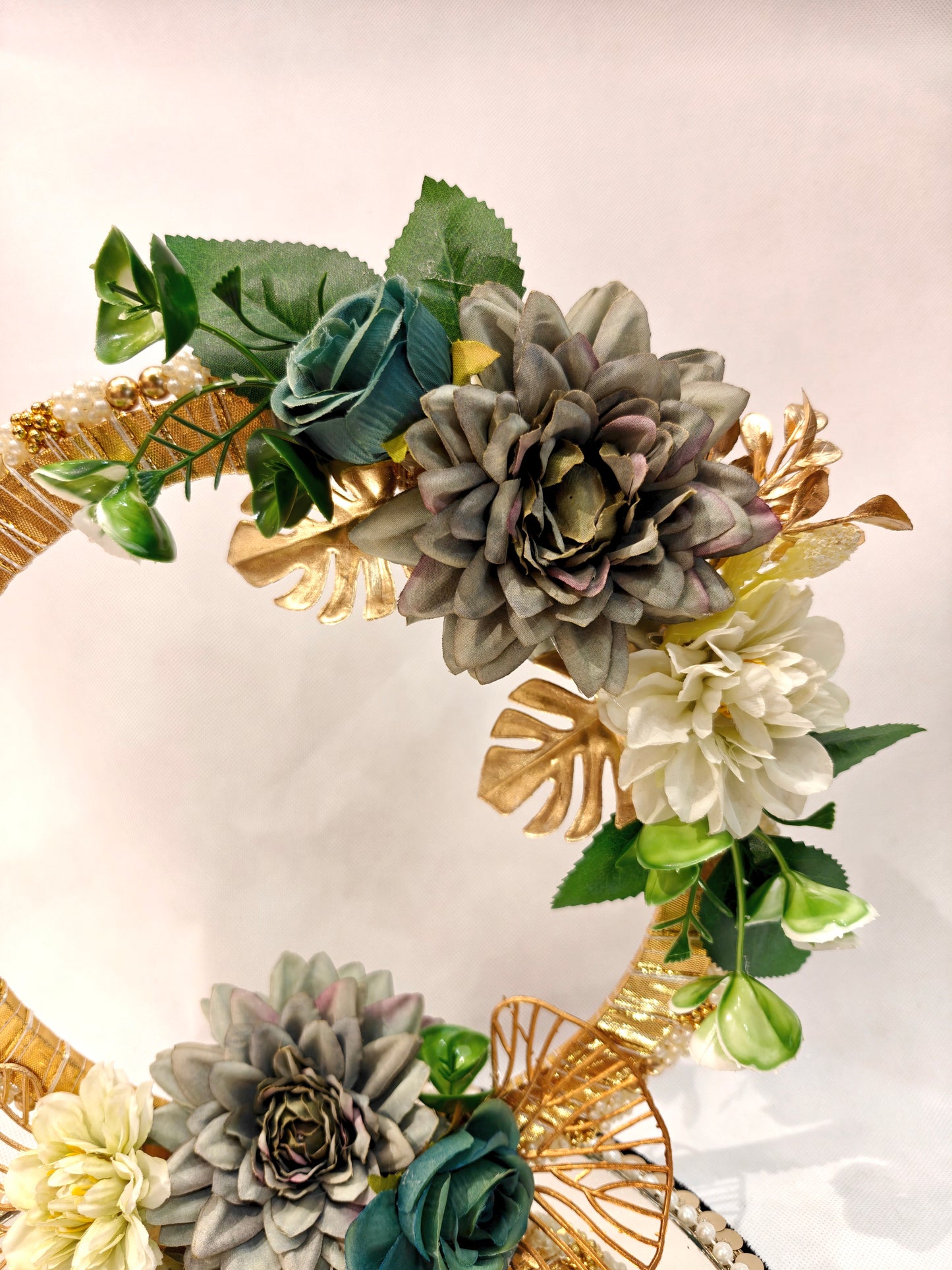 Handcrafted ring ceremony platter with 11-inch mirror MDF base, gold crescent arch, sage green and grey silk flowers, teal roses, pearl-bordered tray, and pearl ring holders — by The Wedding Station