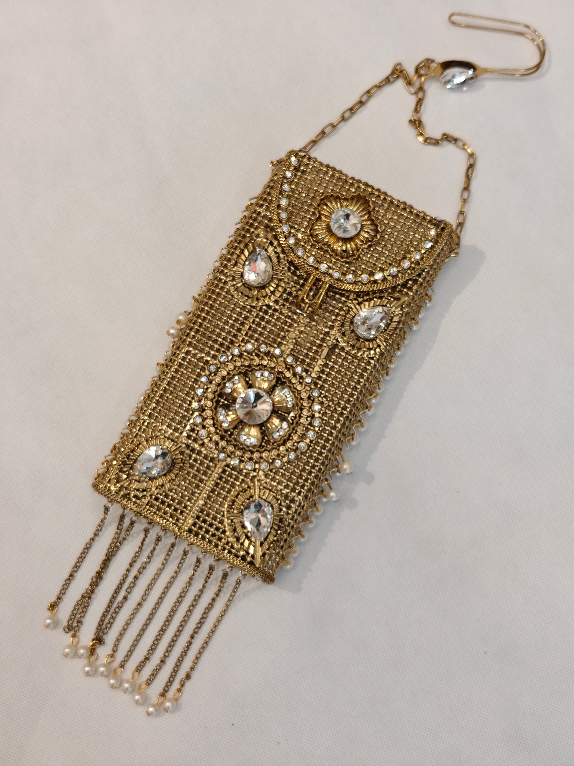 Handcrafted gold brass mesh mobile purse with crystal rhinestone embellishments, floral medallions, pearl chain tassels and short sling — bridal wedding clutch bag by The Wedding Station Meerut
