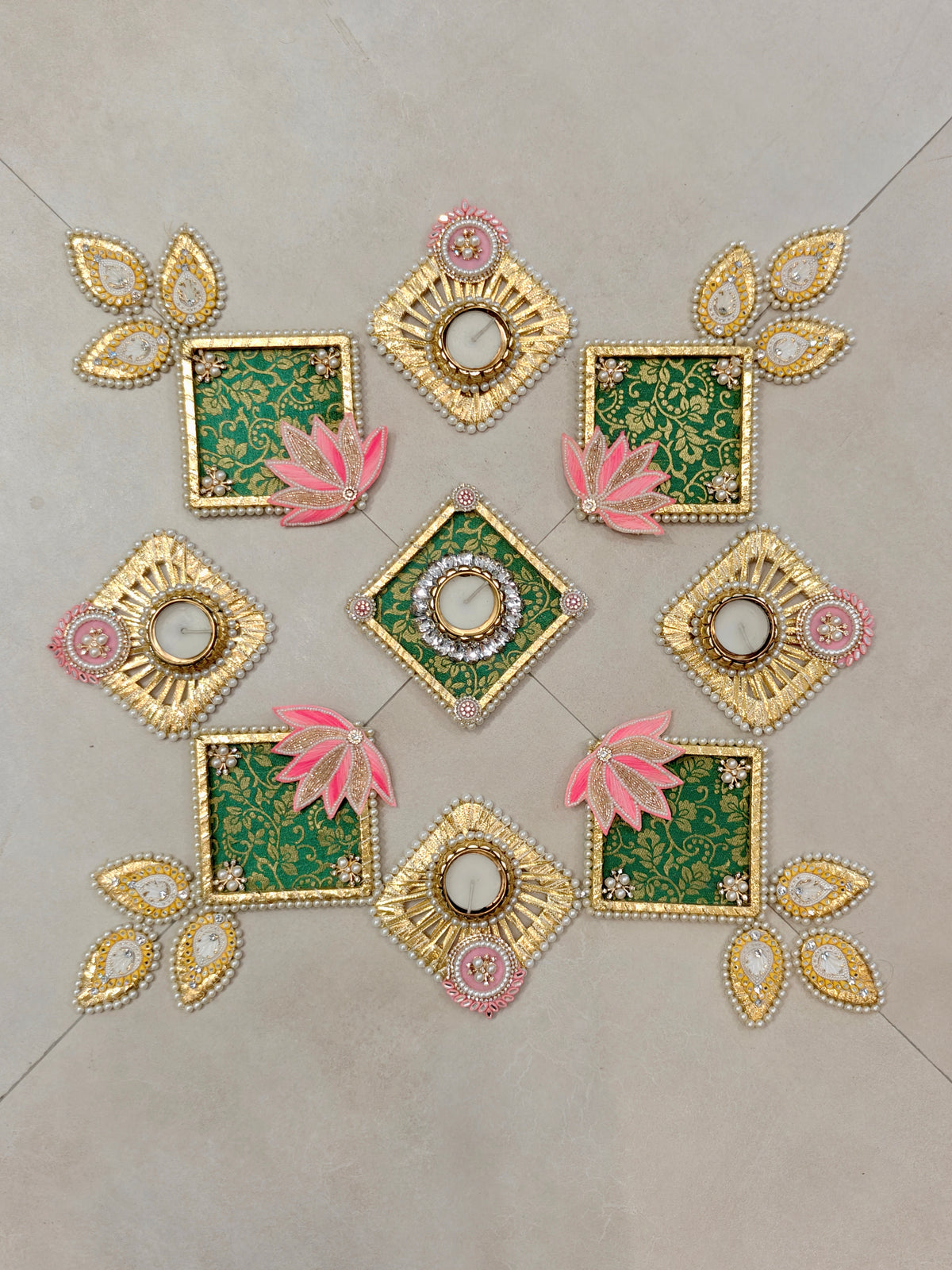 Green brocade rangoli set with pink lotus appliqué and diamond-shaped tealight holders