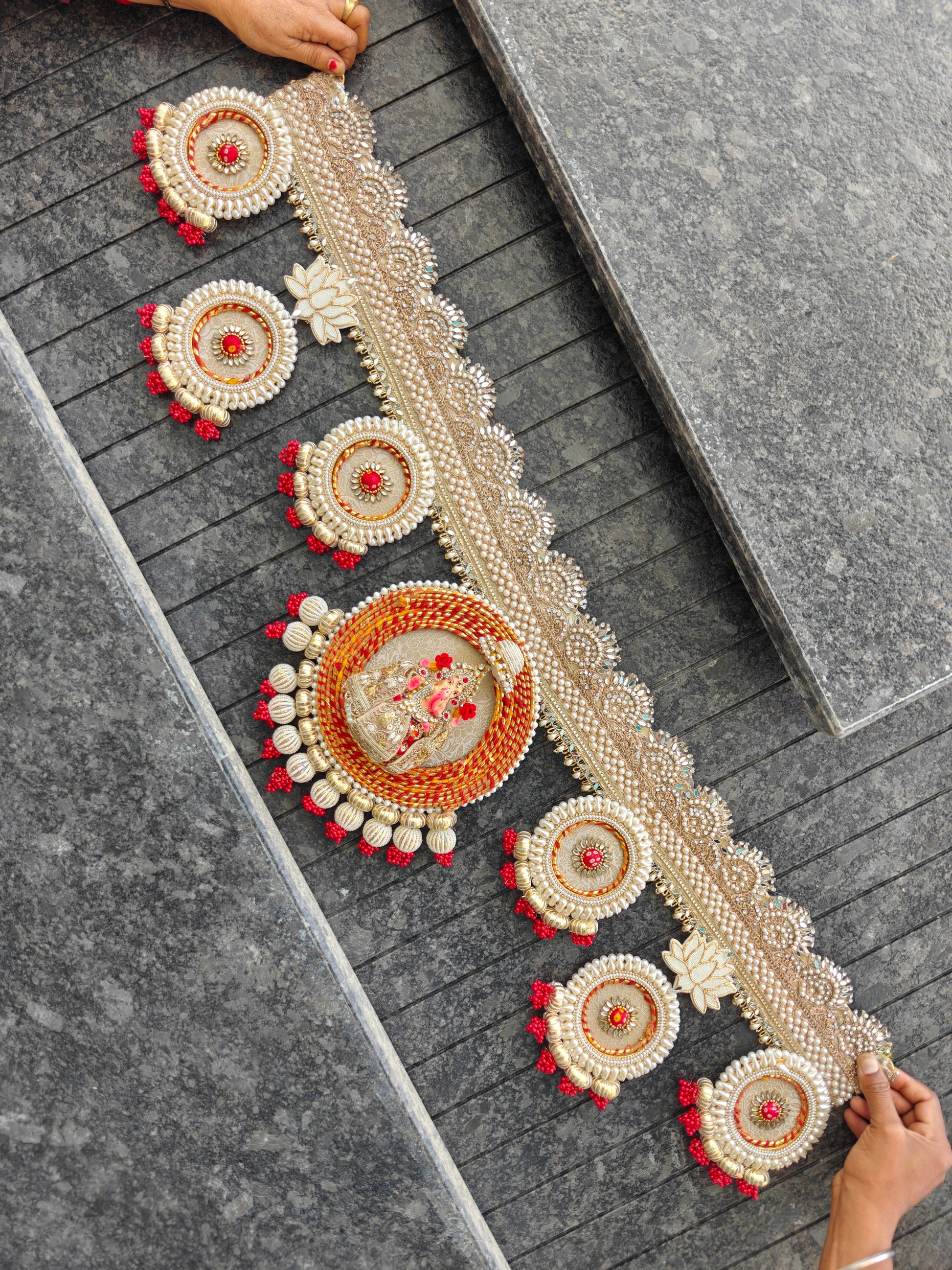 Ganesh idol medallion Bandhanwar with red gold cord frame