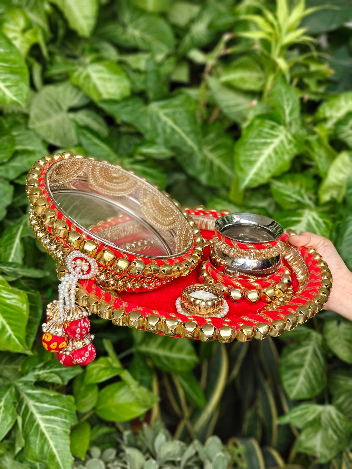 Red and gold Rajsi Ghunghroo Karva Chauth thali set with decorated steel channi, kalash, steel glass, candle and golden ghunghroo border.