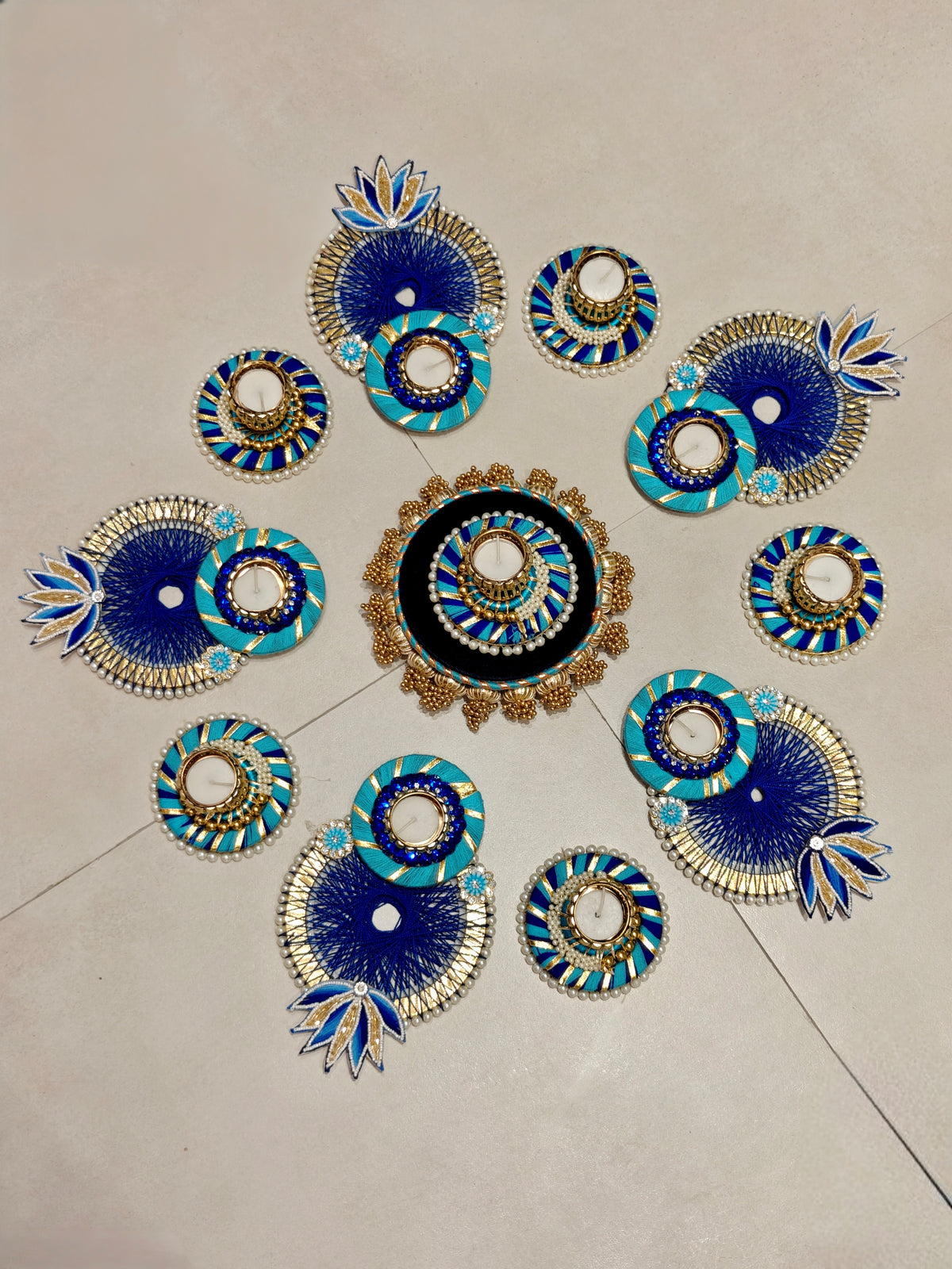 Turquoise and royal blue thread rangoli set with lotus accents and tealight holders