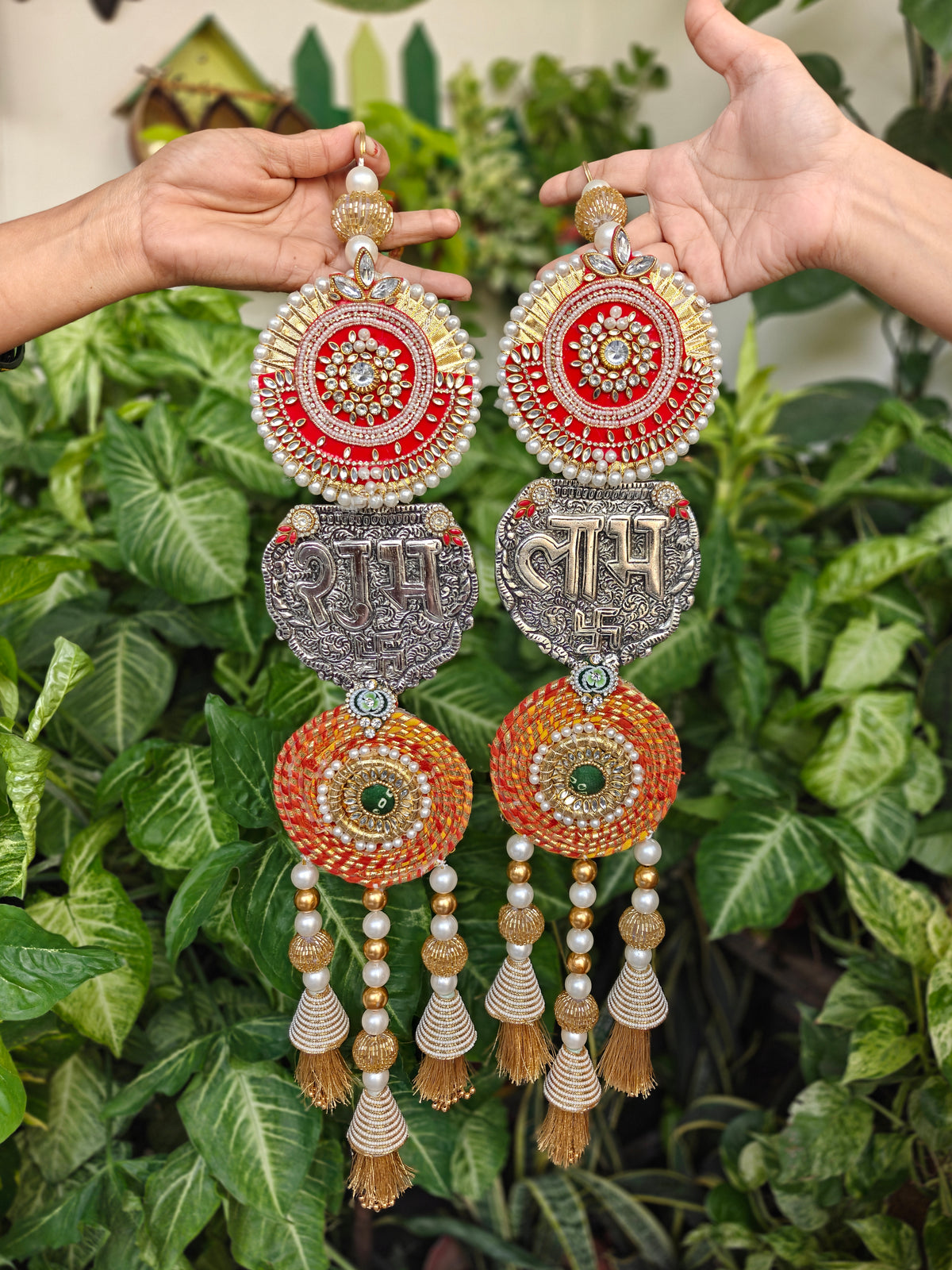 Long Shubh Labh door hanging pair with red kundan medallion, oxidised silver swastik plaque, orange gota spiral and golden tassel latkans