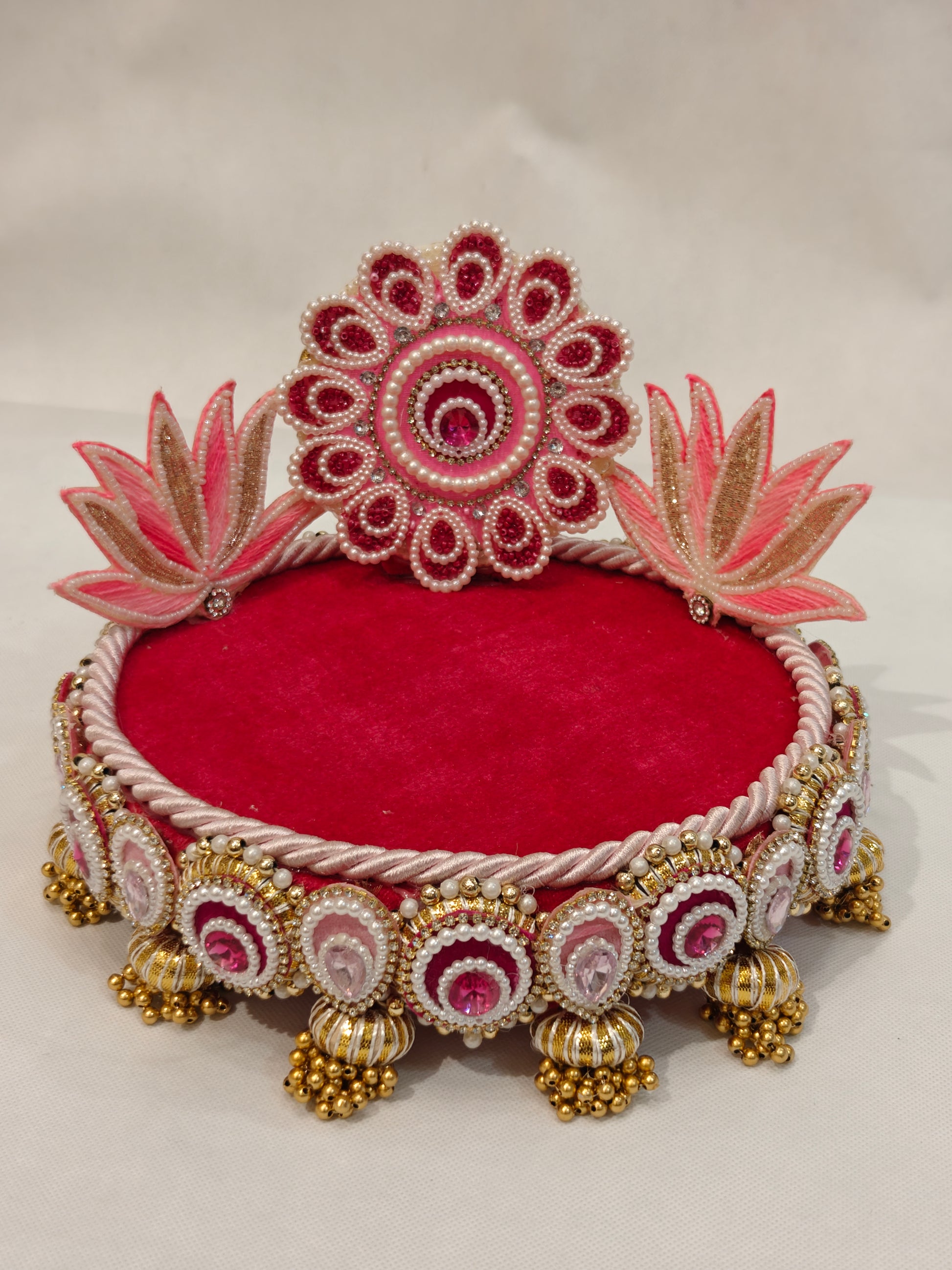 Handcrafted pink lotus Singhaasan for Ladoo Gopal — 8 inch compact MDF deity throne with beaded floral medallion crown, twin lotus blooms, crimson velvet seating, pearl gem border and gold ghungroo tassel drops by The Wedding Station
