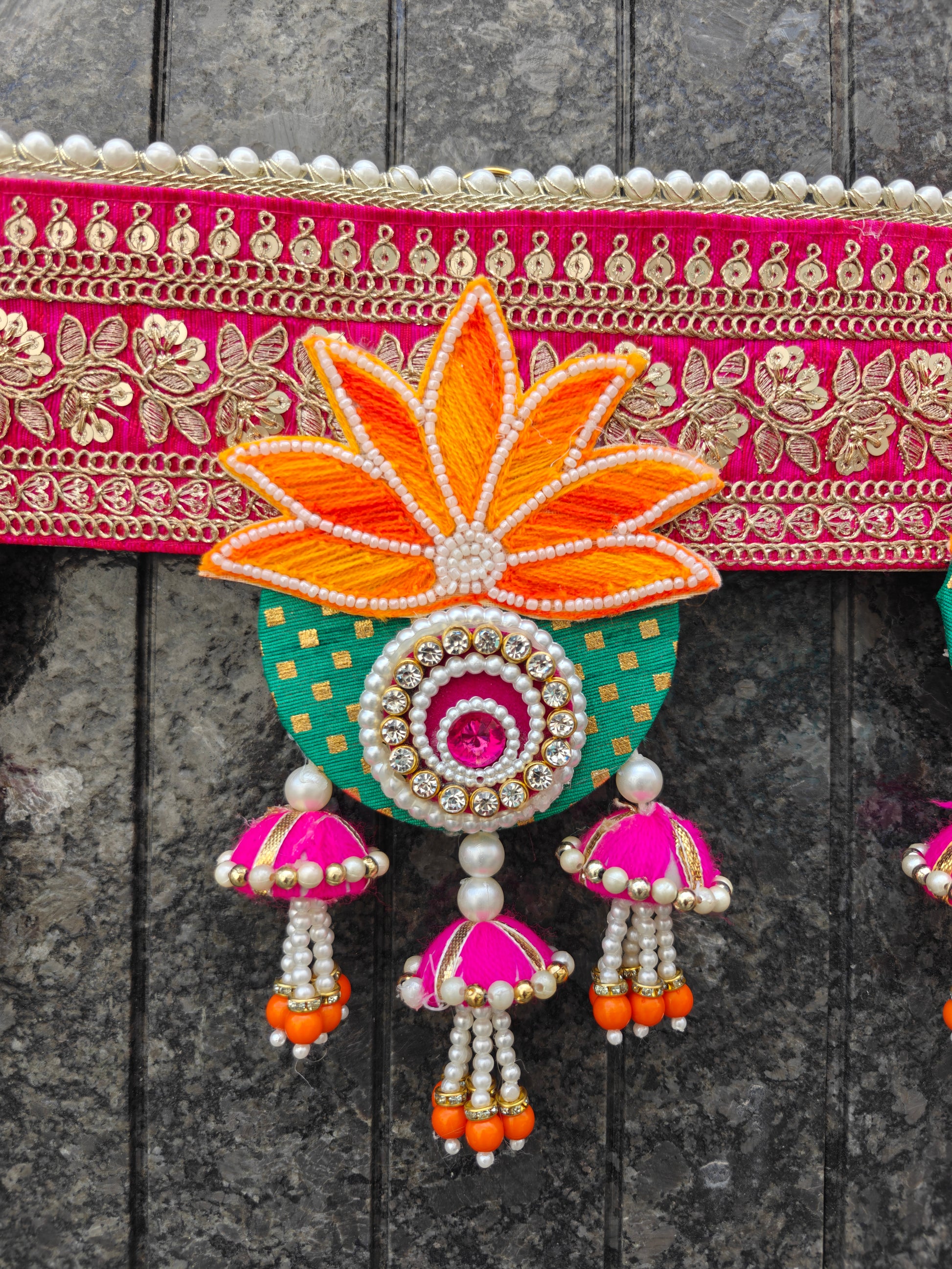 Pink embroidered wedding toran with lotus floral design