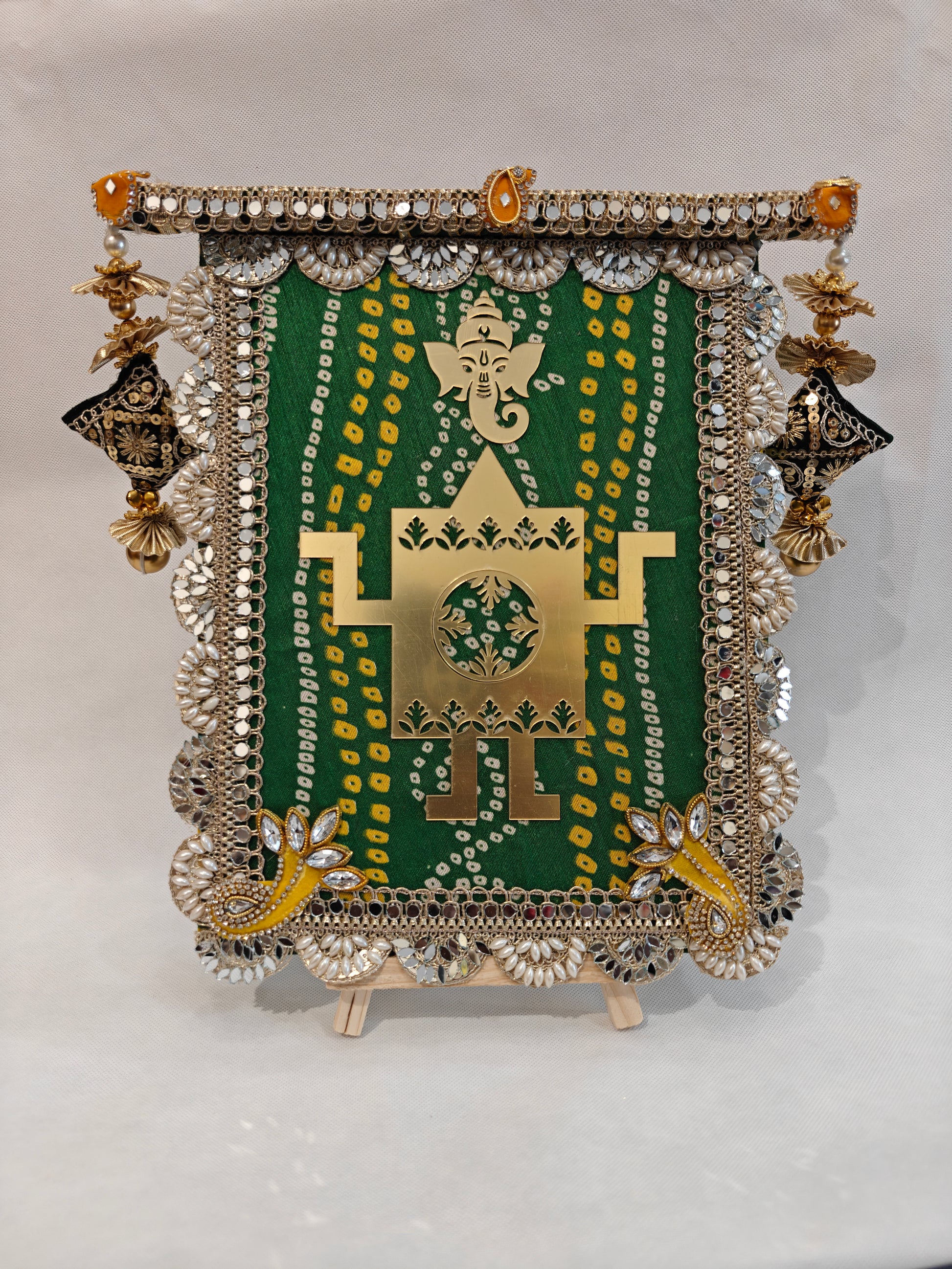 Green bandhani fabric wedding thaapa devta frame with gold Ganesh Swastik cutout, mirror scallop border and antique gold lantern tassels - 9x12 MDF base