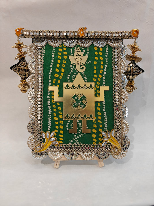 Green bandhani fabric wedding thaapa devta frame with gold Ganesh Swastik cutout, mirror scallop border and antique gold lantern tassels - 9x12 MDF base