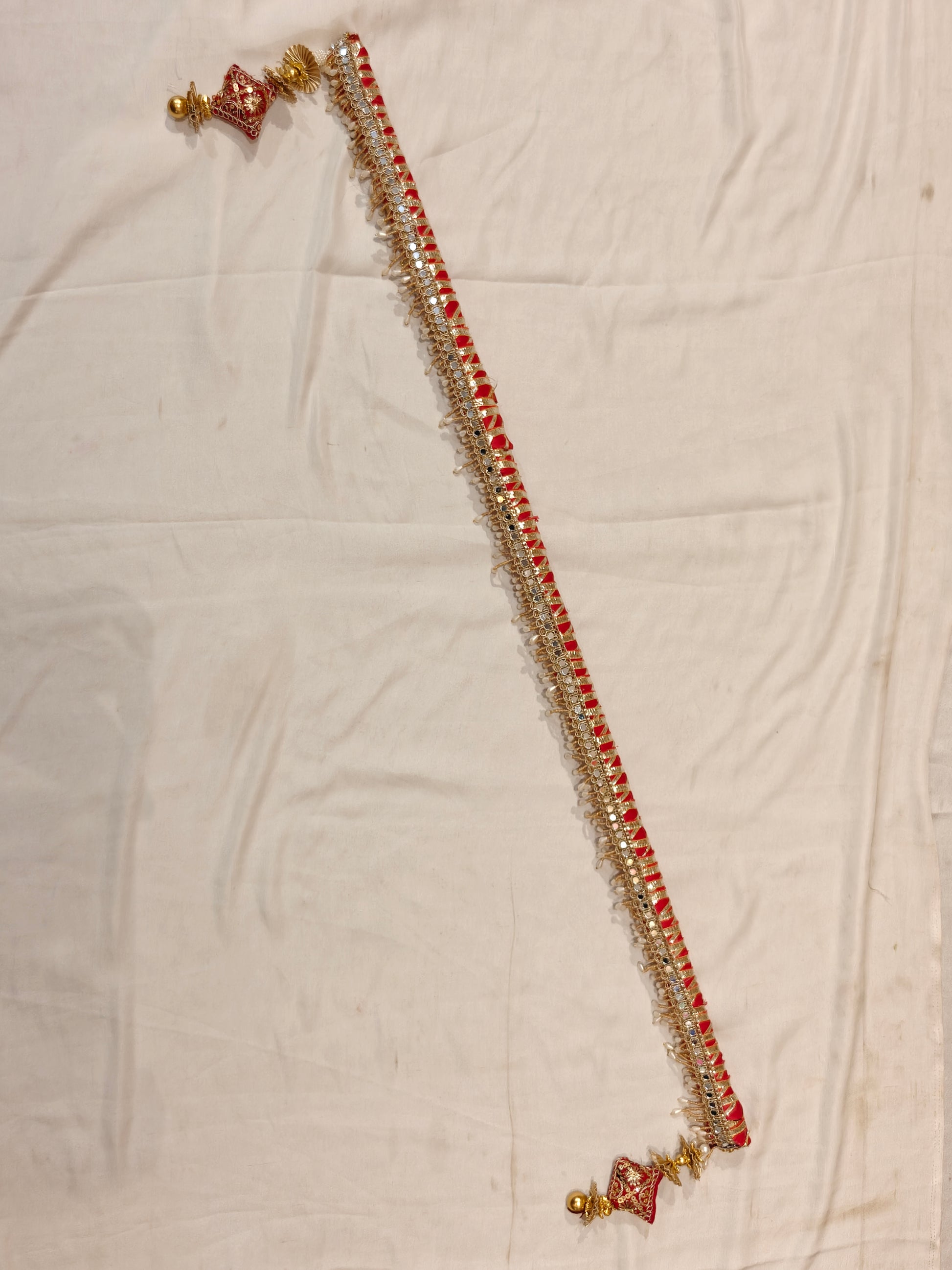 Handcrafted red and gold sarkanda for mandha wedding decoration with mirror work and pearl drops, full length view
