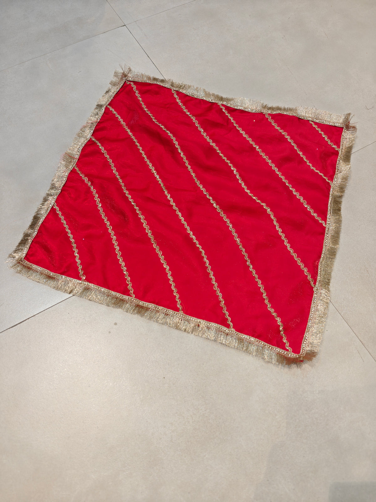 Red 21x21 inch thaal cover with diagonal golden zari lace and golden fringe border, laid flat
